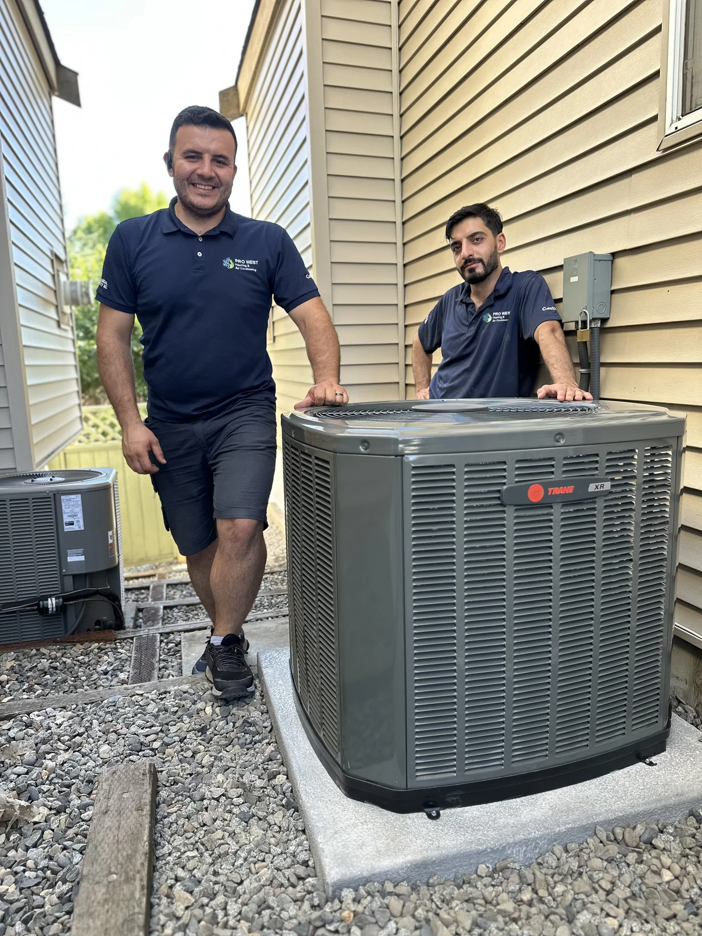 The Pro West team beside a completed heat pump installation
