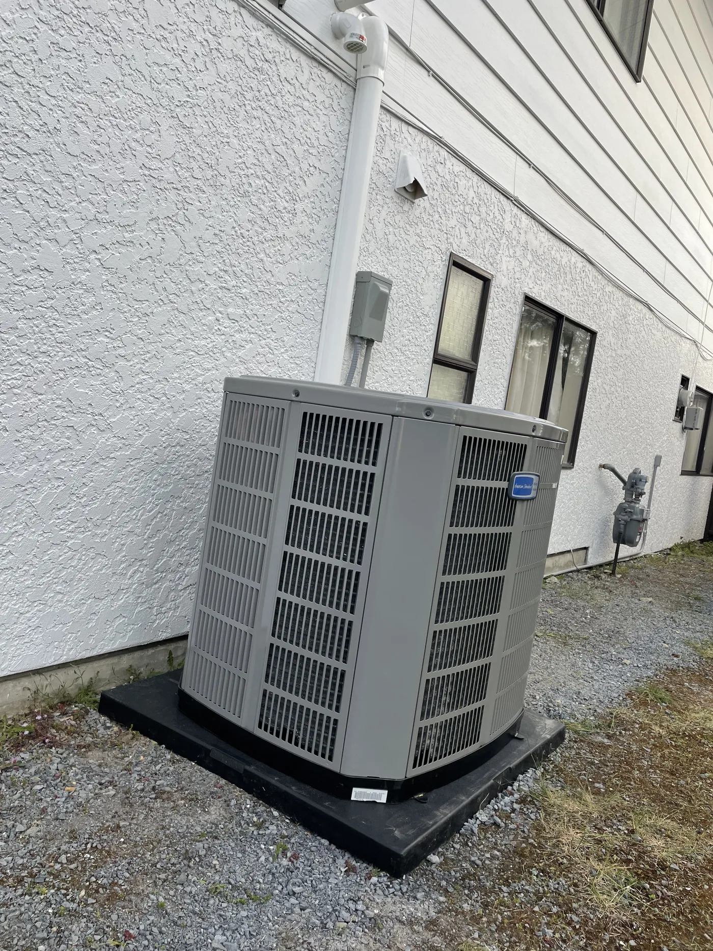 New outdoor unit set level on a composite pad